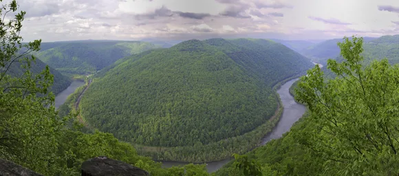 Colored photo looking down into the gorge at a bend in the New River